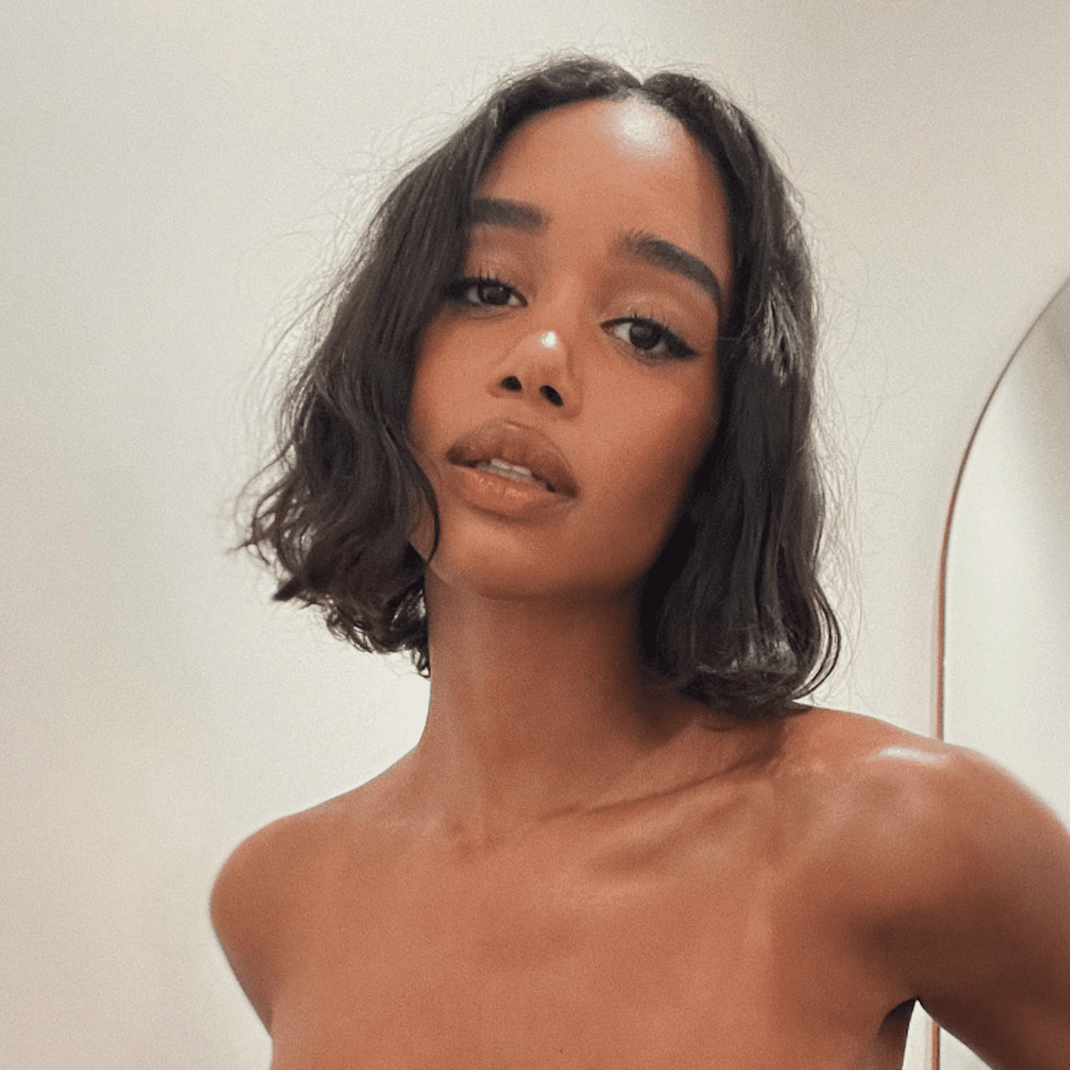 Laura Harrier attends a Burberry event with diffused waves in her long bob