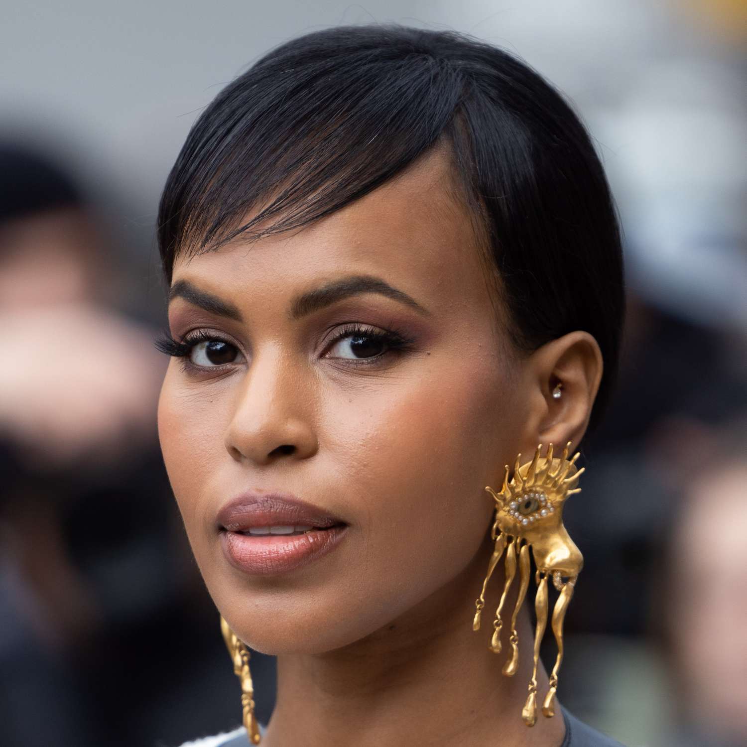 Sabrina Dhowre Elba attends Paris Fashion Week with a softly feathered side bang and sleek pixie