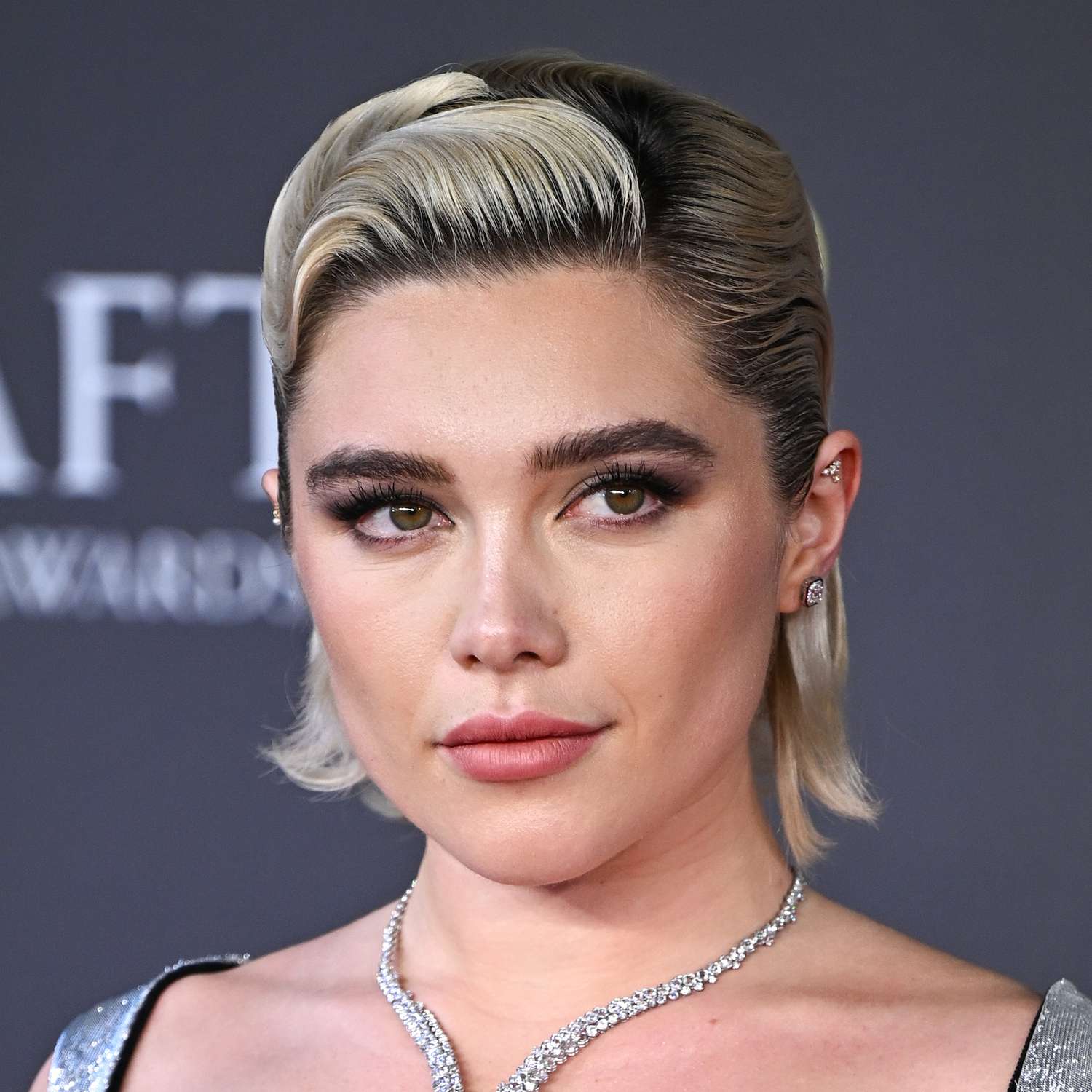 Florence Pugh attends the BAFTA Awards with a firm finger wave design in her long bob