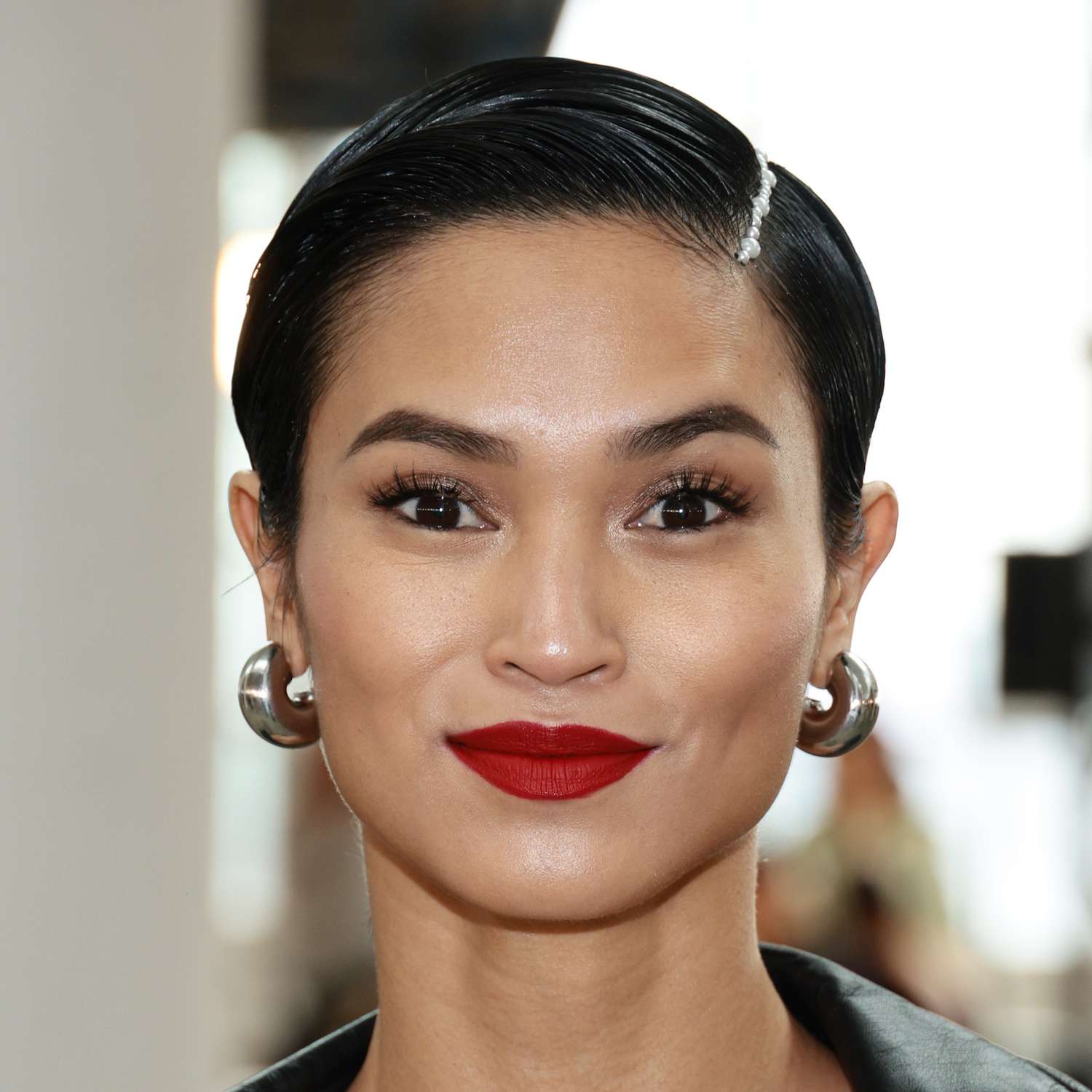 Sharina Gutierrez attends NYFW with a side parted pixie and a pearl strand adorned within her part