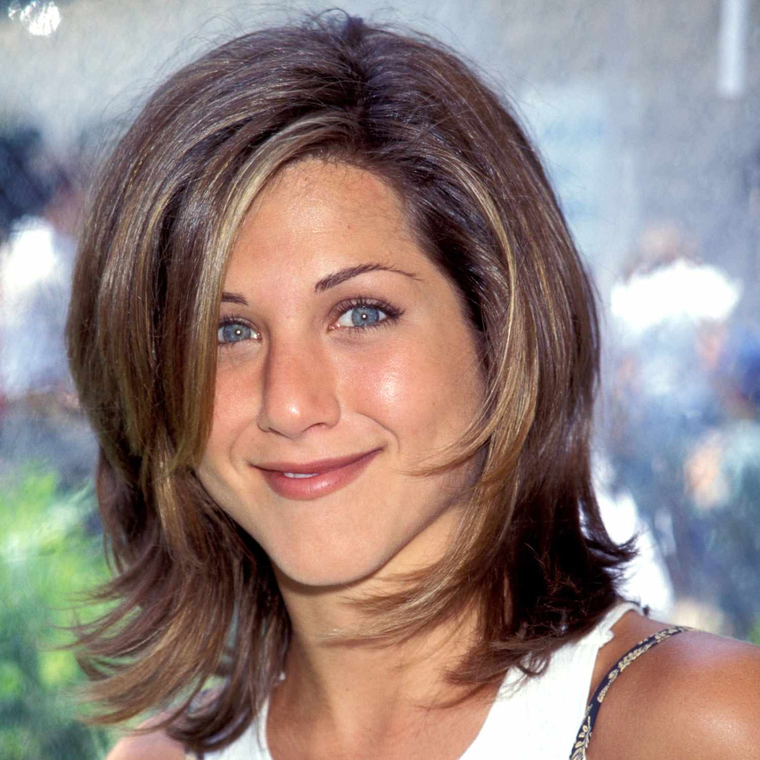 close up of jennifer aniston with short brown choppy layers, hair known as the rachel