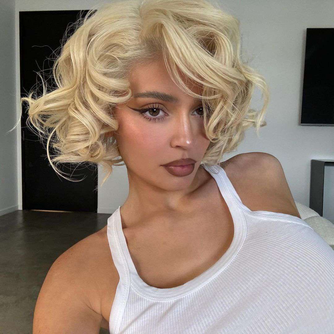 Kylie Jenner wearing a curly blonde bob hairstyle.